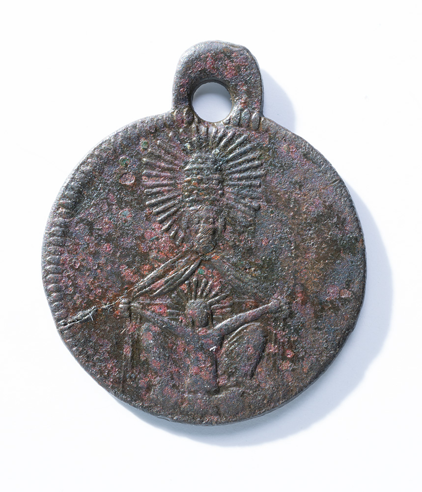Grey and rusty circular medal depicting some unclear markings