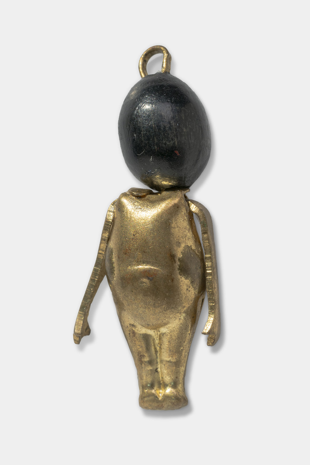 Charm shaped like a stylized baby with a gold-colored body and dark wood head.