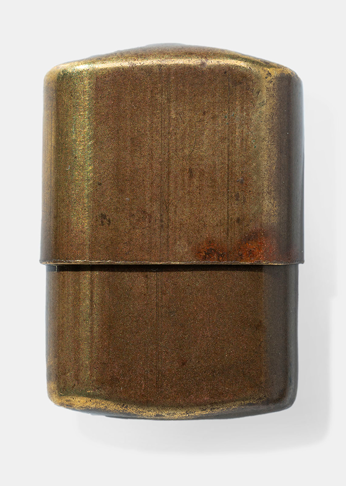 Brass-colored container consisting of two halves. The top half slides down over the bottom half to close the container.