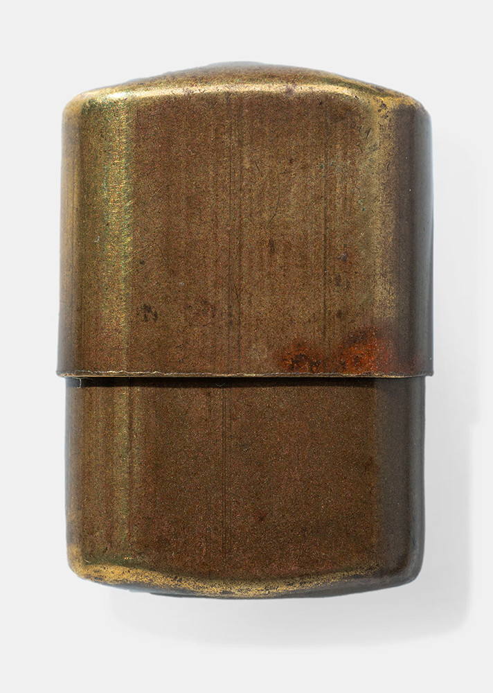 Brass-colored container consisting of two halves. The top half slides down over the bottom half to close the container.